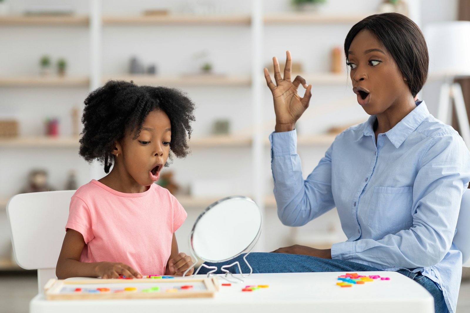 Pretty little black girl attending speech therapy session