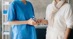 Close up view of old woman leaning on nurse while siting